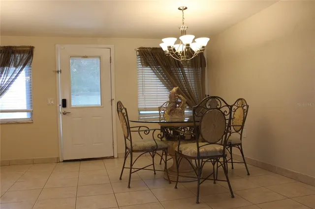 a view of a dining room with furniture and chandelier