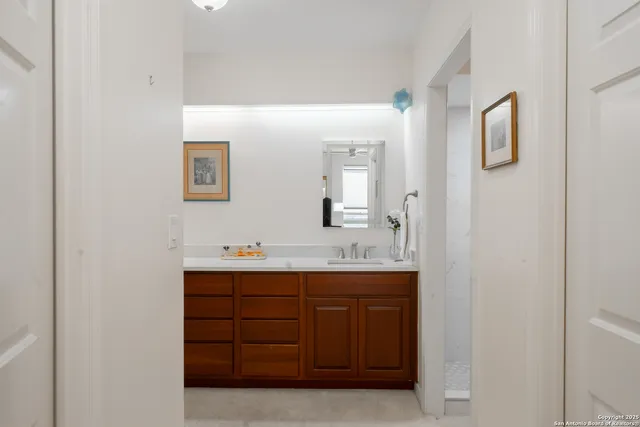a bathroom with a double vanity sink and mirror
