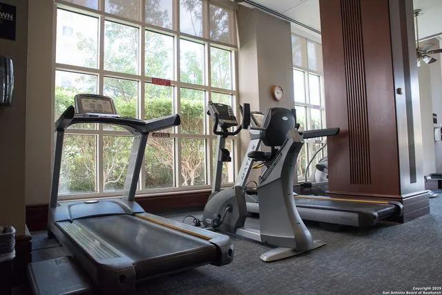 a room with gym equipment and windows