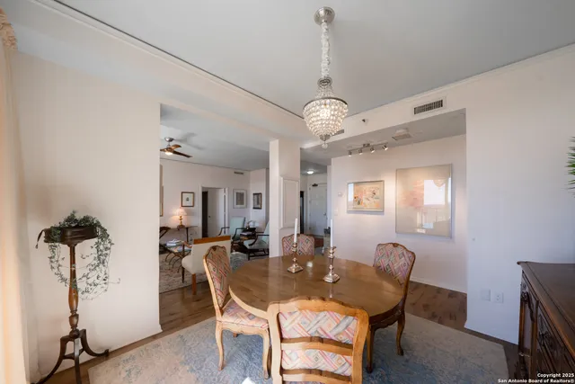 a view of a dining room with furniture and chandelier
