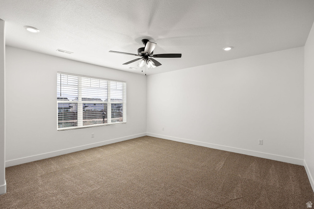 1661 West Ross Road Syracuse, UT 84075 - Photo 15 of 28 Empty room with light carpet and a ceiling fan