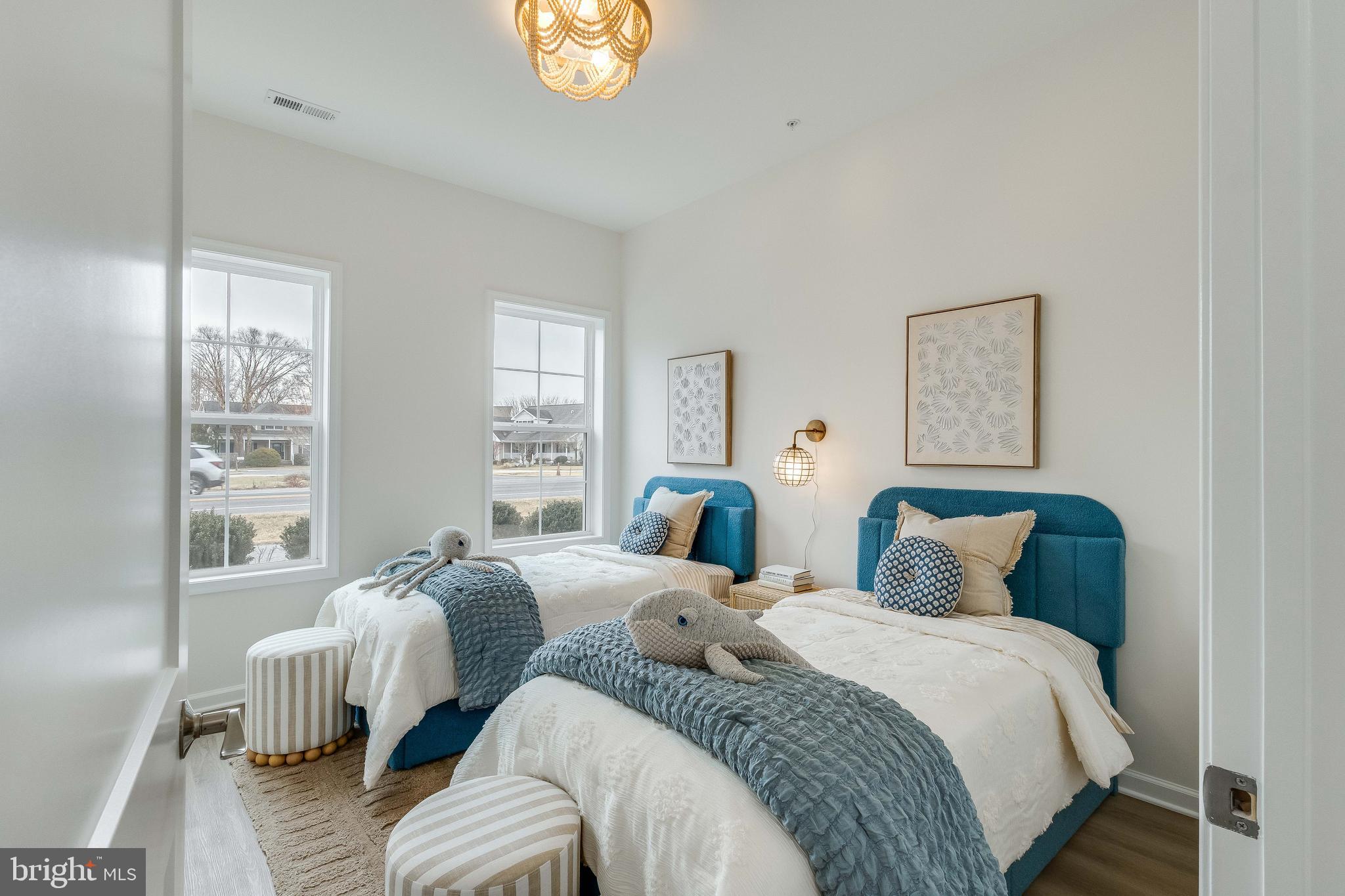 2 Bowers Drive, Unit 103 Ocean View, DE 19970 - Photo 16 of 52 a bedroom with two beds and a large window