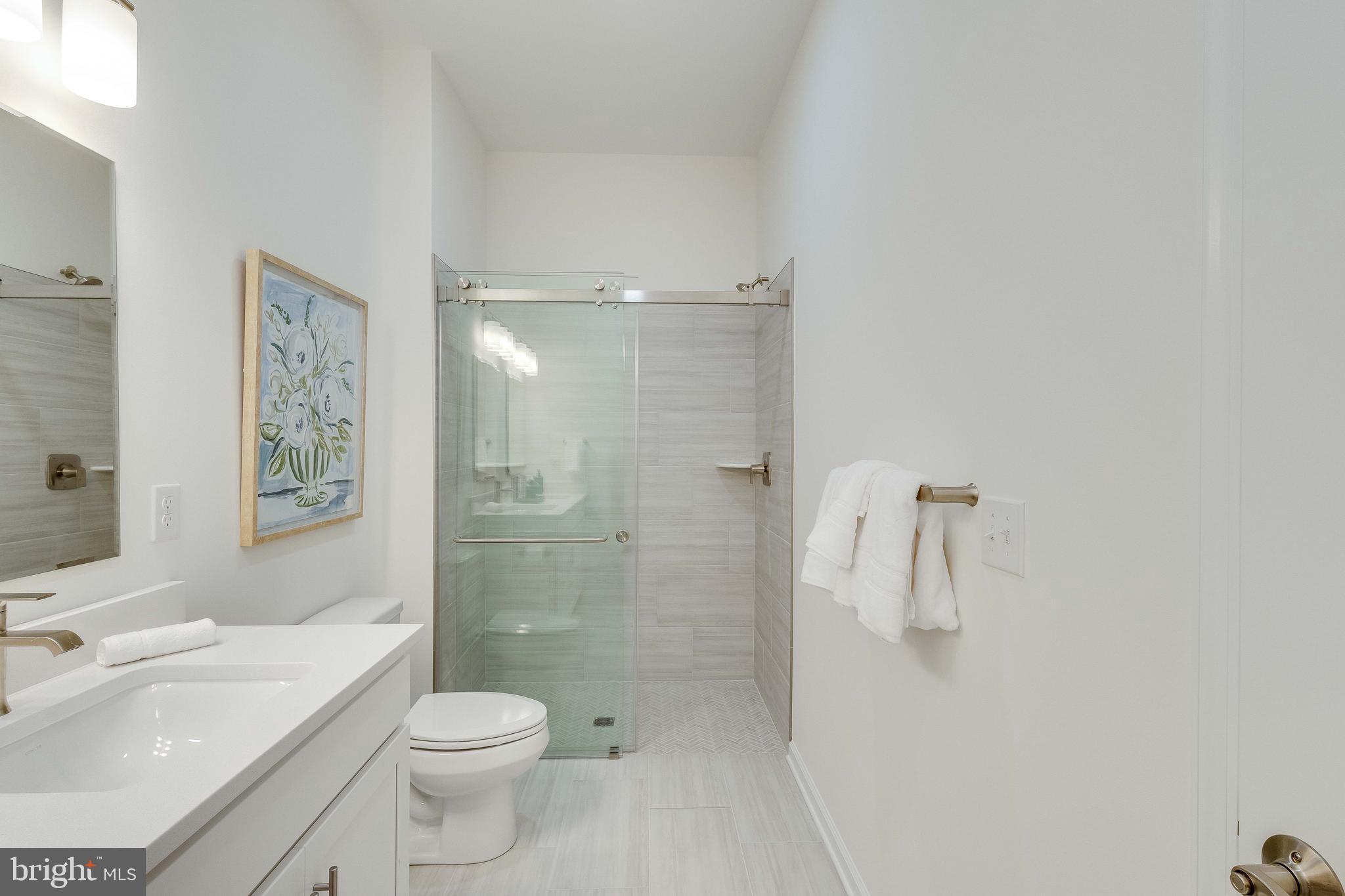 2 Bowers Drive, Unit 103 Ocean View, DE 19970 - Photo 18 of 52 a bathroom with a sink a toilet and shower