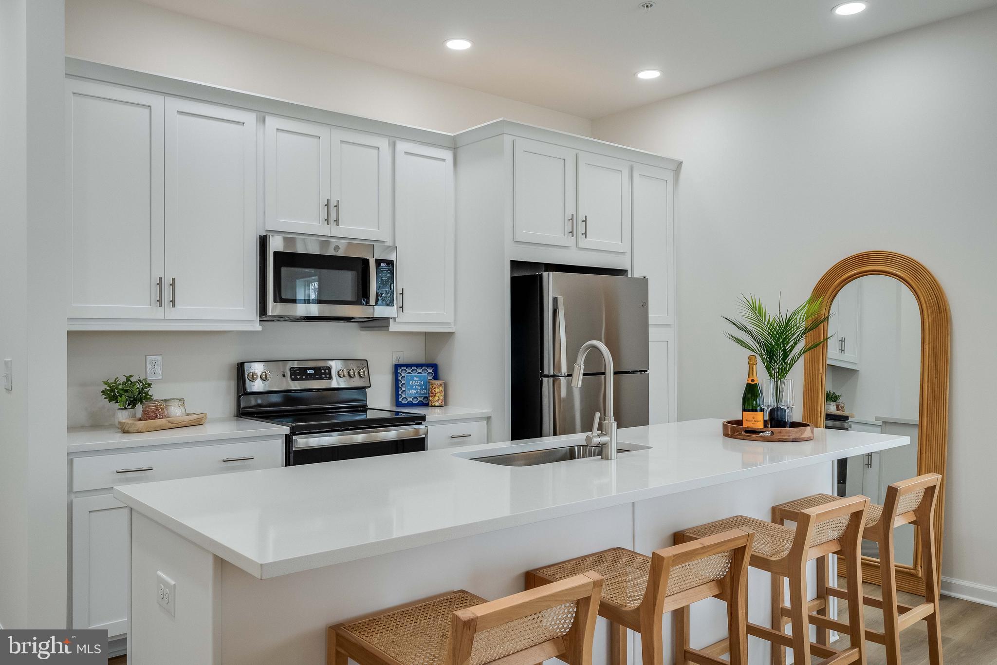 2 Bowers Drive, Unit 103 Ocean View, DE 19970 - Photo 6 of 52 a kitchen with stainless steel appliances a stove a sink a microwave and a refrigerator