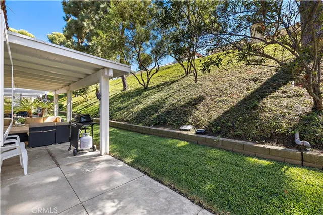 a front view of a house with a yard and outdoor seating