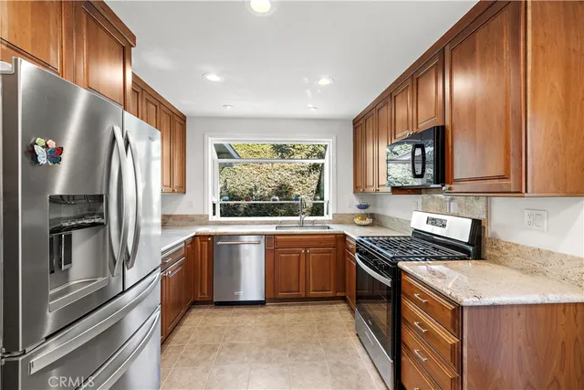 a kitchen with granite countertop a sink and a window