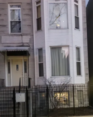 a view of a brick house with large windows