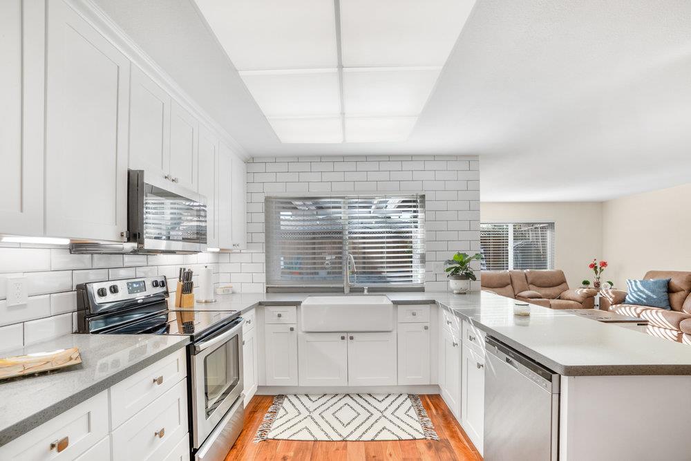 1408 Eagles Nest Lane Gilroy, CA 95020 - Photo 12 of 43 a kitchen with a sink stove and cabinets