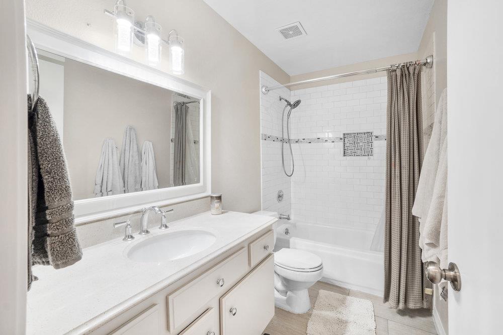 1408 Eagles Nest Lane Gilroy, CA 95020 - Photo 20 of 43 a bathroom with a granite countertop sink toilet a shower and a mirror