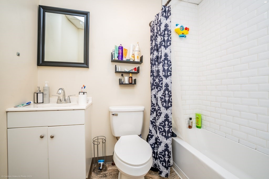 772 Globe Street Fall River, MA 02724 - Photo 17 of 23 a bathroom with a sink a toilet and a mirror