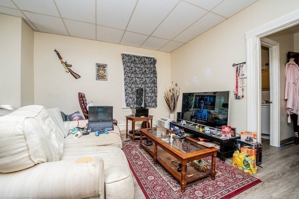 772 Globe Street Fall River, MA 02724 - Photo 20 of 23 a living room with furniture a flat screen tv and a fireplace