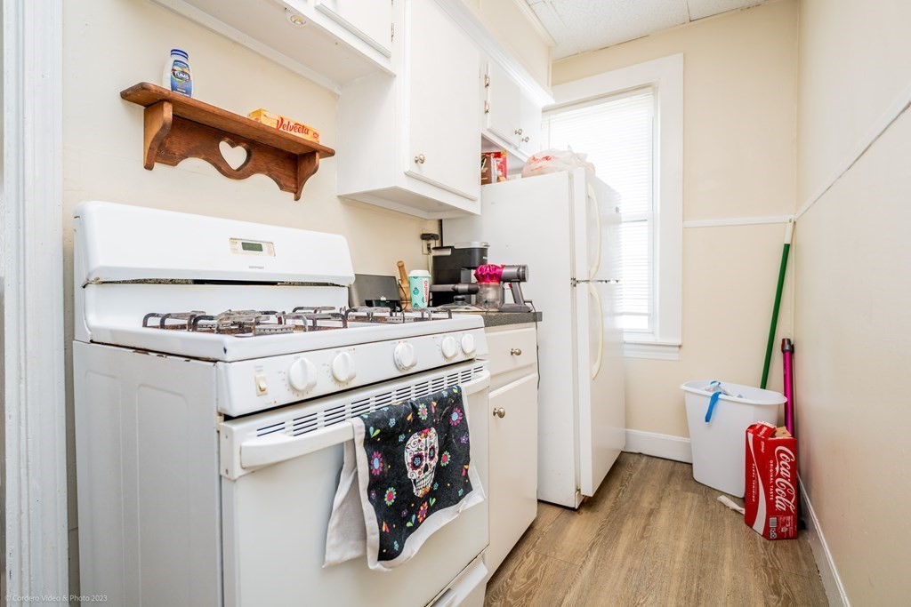 772 Globe Street Fall River, MA 02724 - Photo 8 of 23 a kitchen with stove and wooden floor