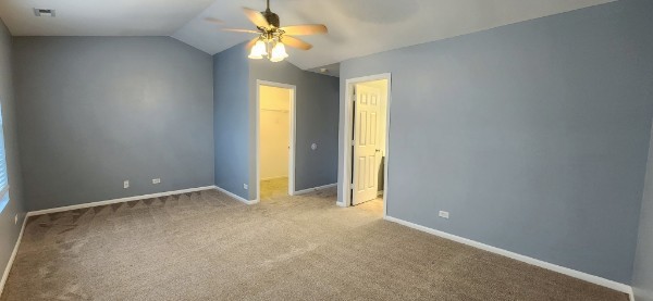 24113 Walnut Circle Plainfield, IL 60585 - Photo 20 of 21 an empty room with a chandelier fan and windows