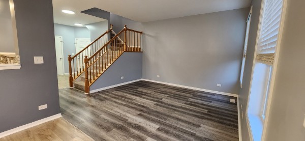 24113 Walnut Circle Plainfield, IL 60585 - Photo 2 of 21 a view of a hallway with wooden floor and staircase