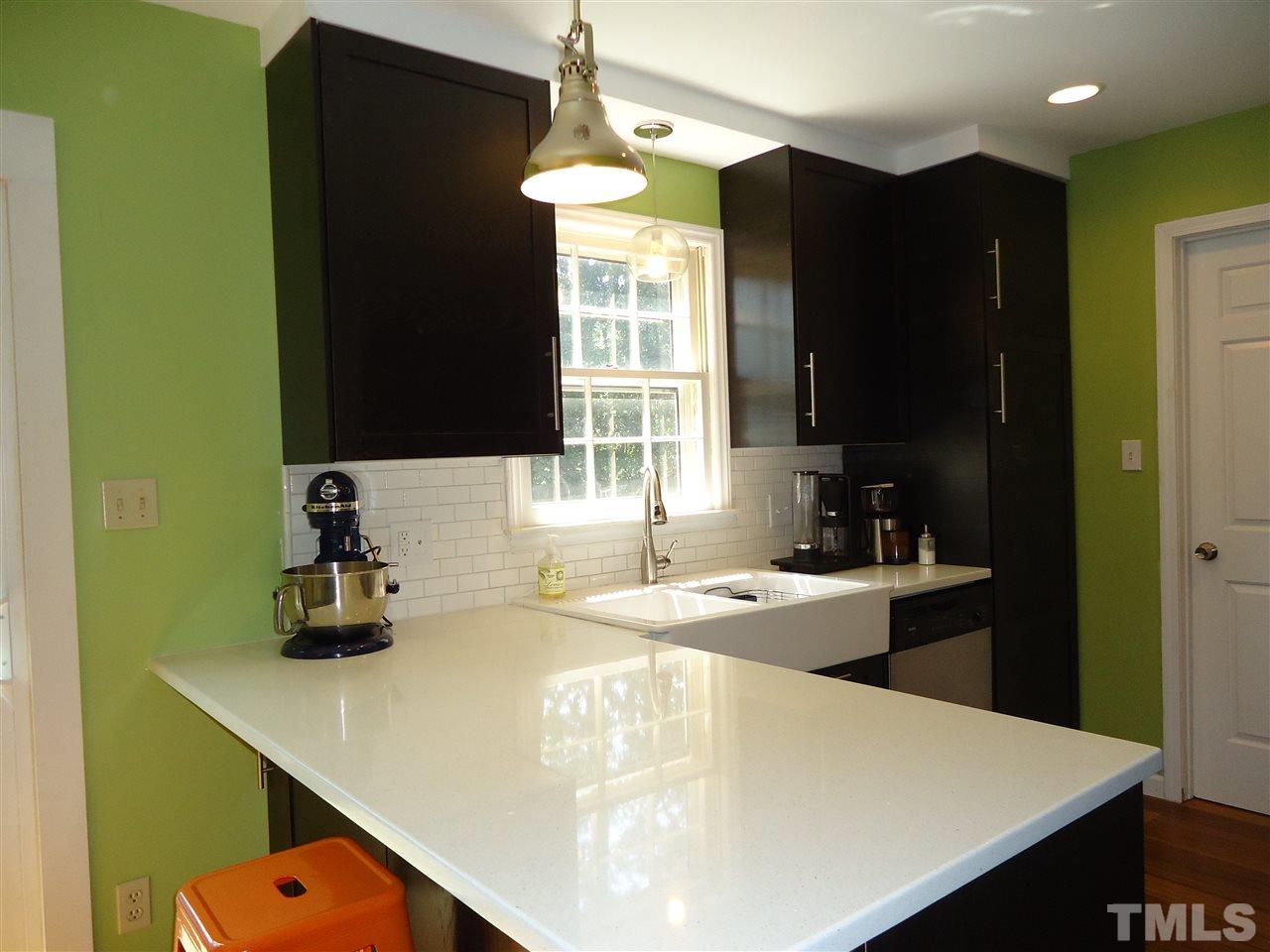 3616 Wickersham Way Raleigh, NC 27604 - Photo 8 of 23 a kitchen with a sink a stove and refrigerator