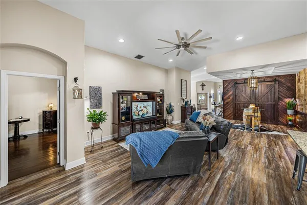 a open kitchen with stainless steel appliances granite countertop a kitchen island a stove a table and chairs