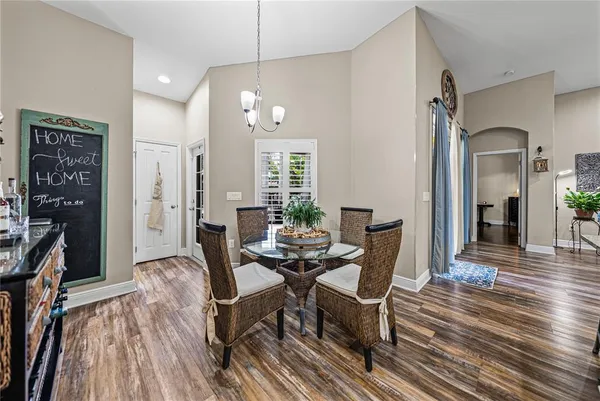a spacious bathroom with a granite countertop double vanity sink a mirror and a shower