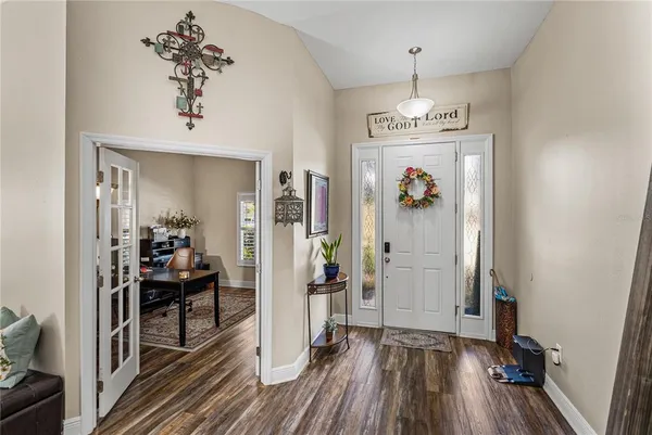 a view of a workspace with furniture and a ceiling fan
