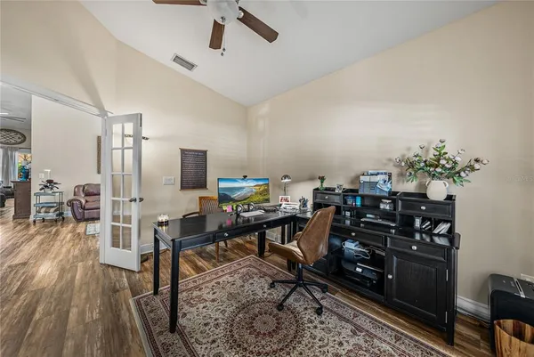 a living room with furniture and a floor to ceiling window