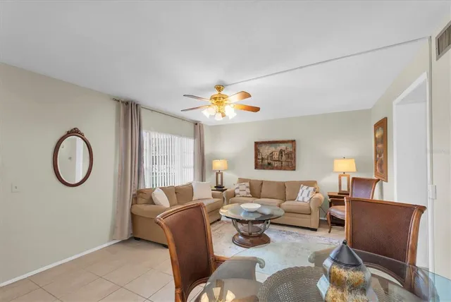 a living room with furniture a chandelier and a window