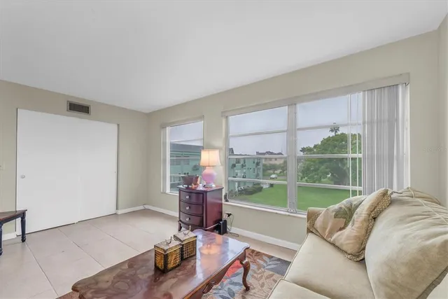 a living room with furniture and a floor to ceiling window