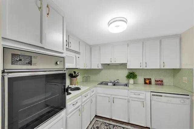 a kitchen with cabinets stainless steel appliances and a counter space