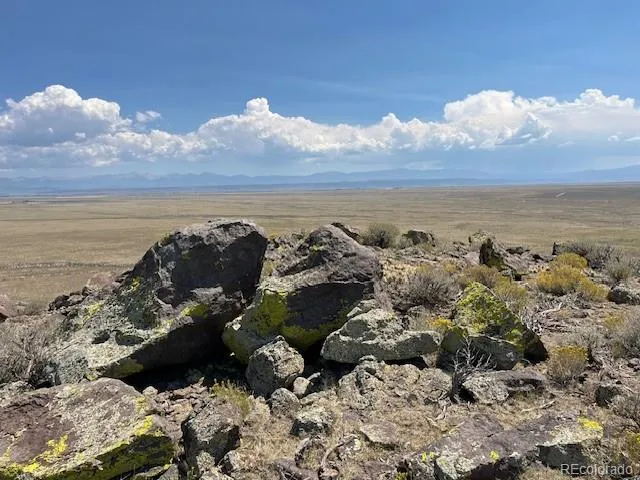 a view of a large mountain with mountains in the background