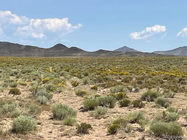 a view of a large building with mountains in the background