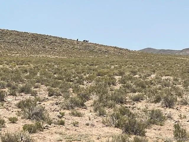 a view of a large building with mountains in the background