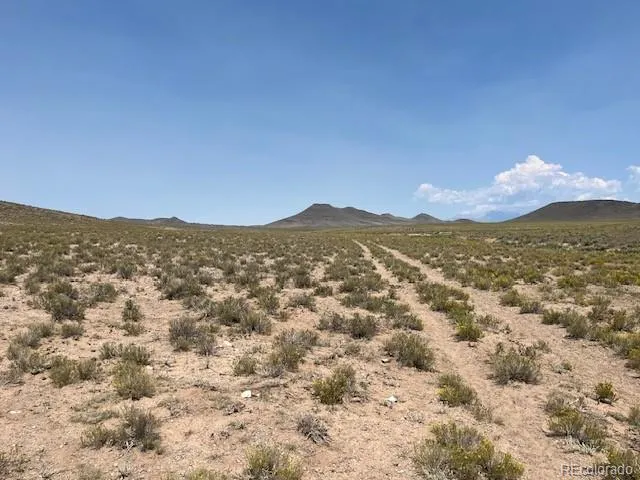 a view of a mountain range with lush green forest