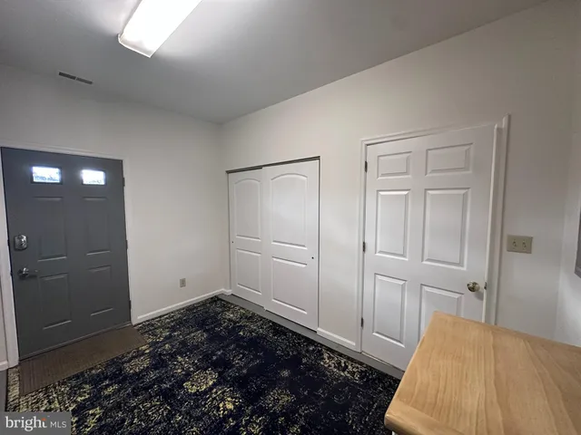 a bedroom with a bed and a rug