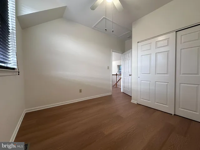 an empty room with a empty space and a ceiling fan