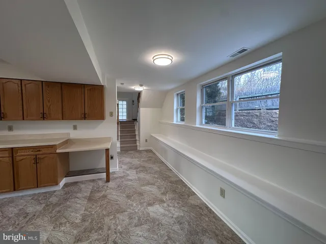 a kitchen with cabinets and window