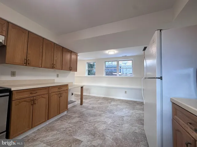 a kitchen with cabinets and window
