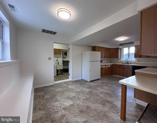 a view of a kitchen with a sink and cabinets