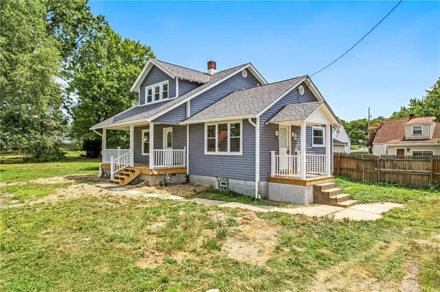 a view of a house with a yard patio and a garden