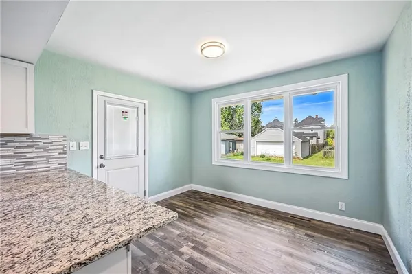 a large kitchen with a refrigerator and a stove top oven