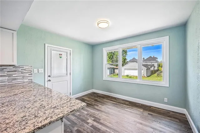 a large kitchen with a refrigerator and a stove top oven