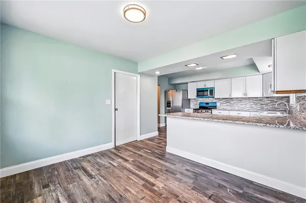 a kitchen with a sink stove and cabinets