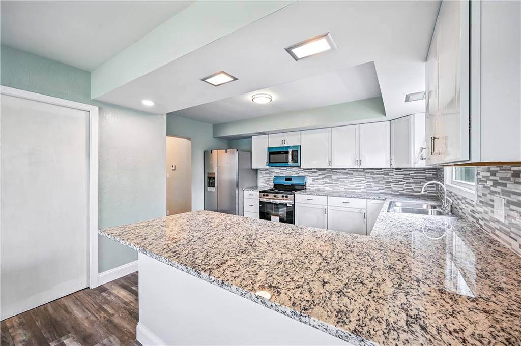674 Deforest Court Sharon, PA 16146 - Photo 16 of 45 a kitchen with stainless steel appliances granite countertop a sink refrigerator and cabinets
