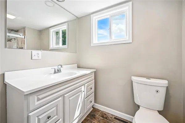 a white toilet sitting next to a bathroom sink and shower