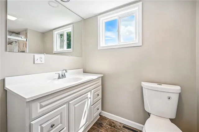 a white toilet sitting next to a bathroom sink and shower