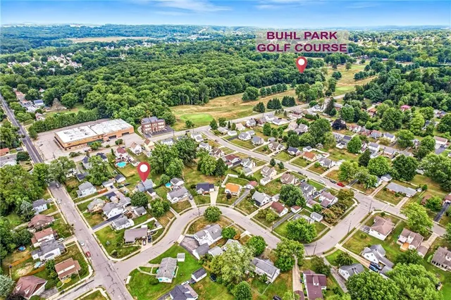 an aerial view of a house with a swimming pool yard and outdoor seating