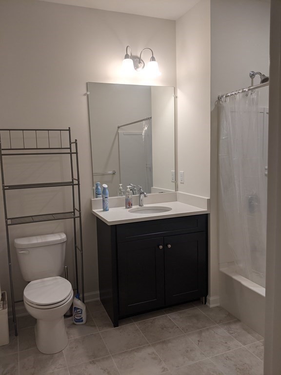 70 Trotter Road, Unit 312 Weymouth, MA 02190 - Photo 17 of 18 a bathroom with a sink vanity mirror and toilet