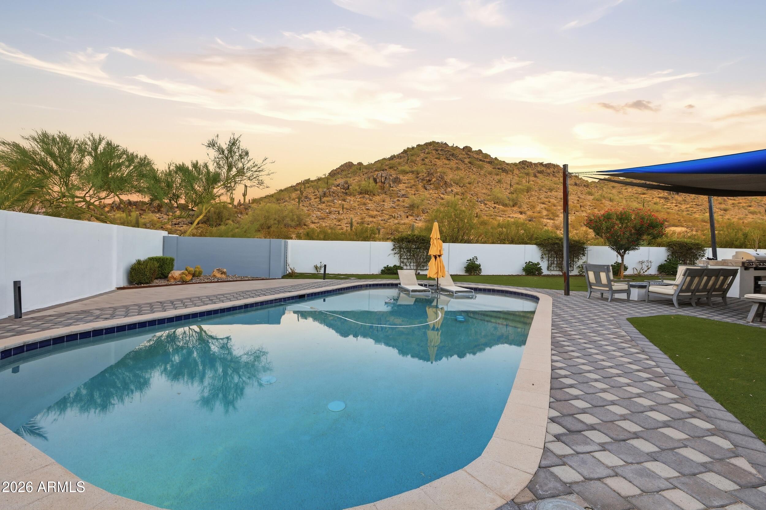 4417 East Mountain View Road Phoenix, AZ 85028 - Photo 33 of 41 a view of a swimming pool with a table and chairs