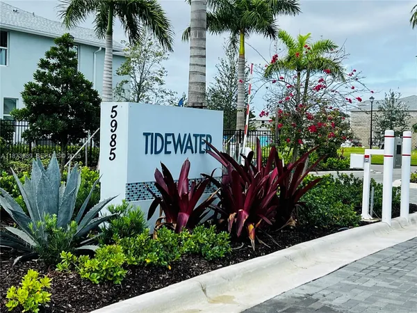 a sign that is in front of flowers