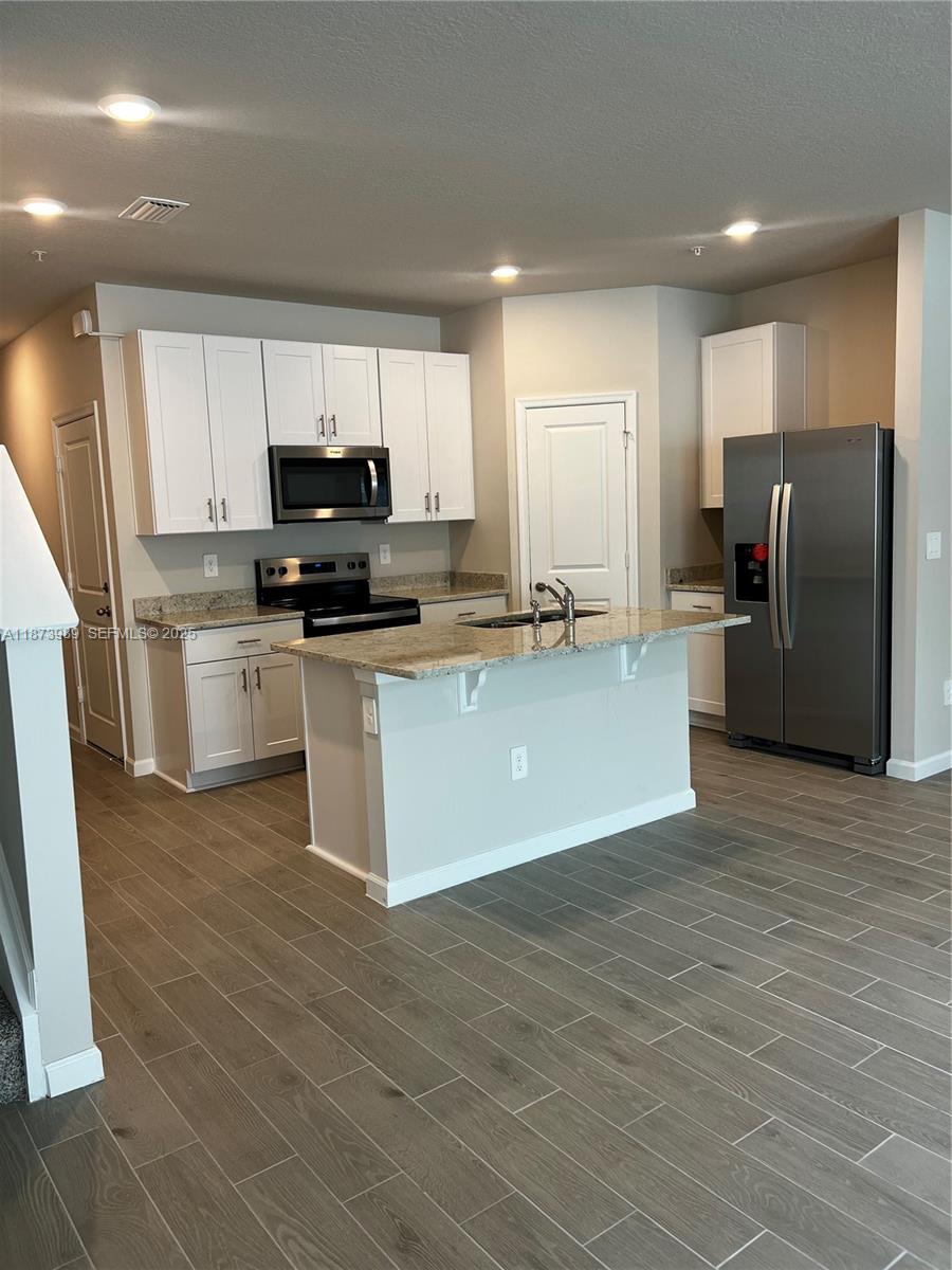 478 Salisbury Circle Fort Pierce, FL 34982 - Photo 3 of 11 a kitchen with stainless steel appliances a refrigerator sink and microwave
