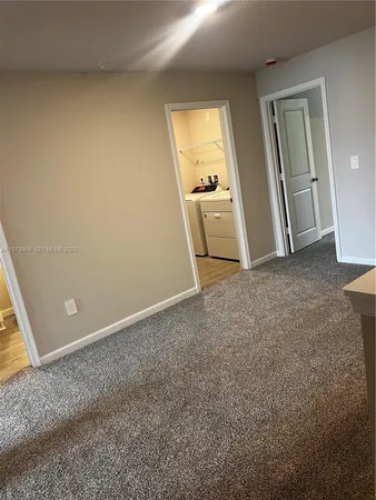 an empty room with windows and closet