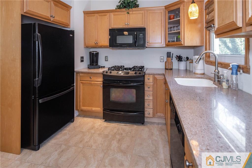 32 Colburn Road East Brunswick, NJ 08816 - Photo 8 of 40 a kitchen with stainless steel appliances granite countertop a refrigerator stove and sink