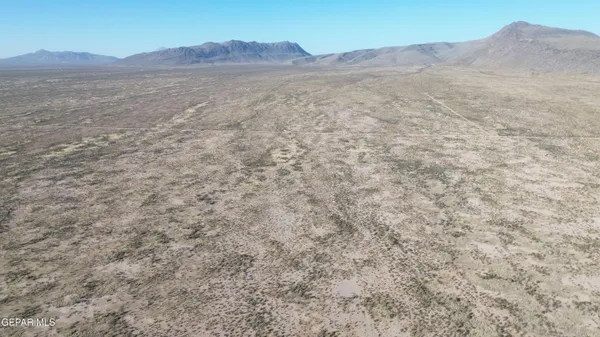 a view of mountain and a field